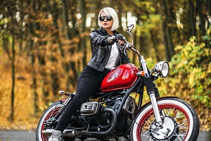 blonde girl sitting on red motorcycle